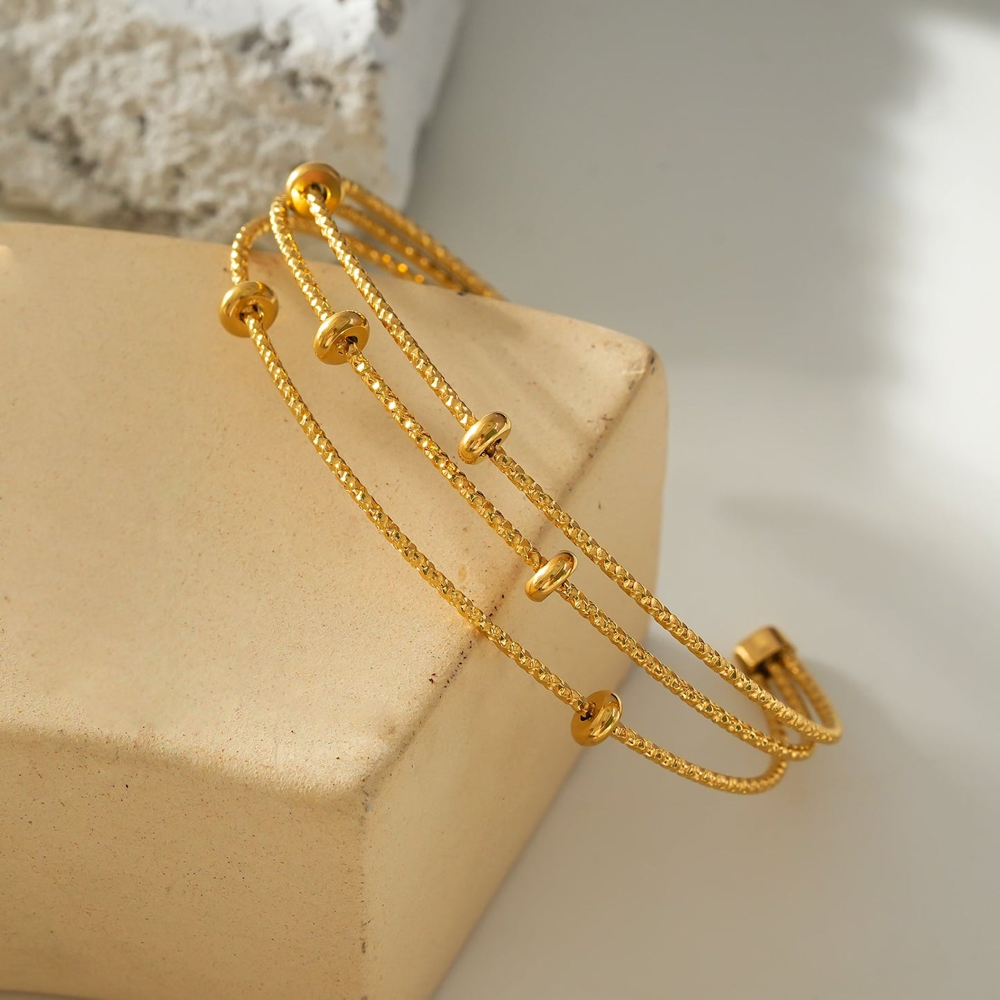 Style FARZIKA Gold: Triple Stacked Textured Beaded Bracelet