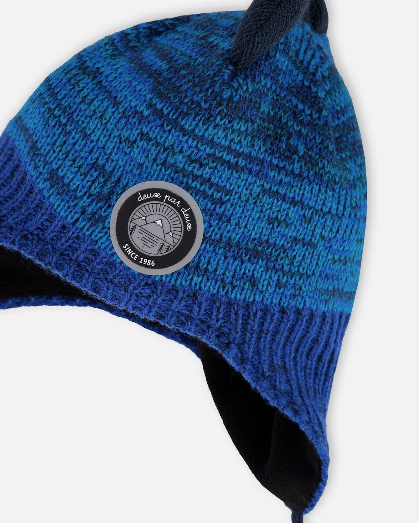 Bonnet péruvien tricoté doublé motif dinosaure avec pompon bleu