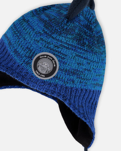 Bonnet péruvien tricoté doublé motif dinosaure avec pompon bleu