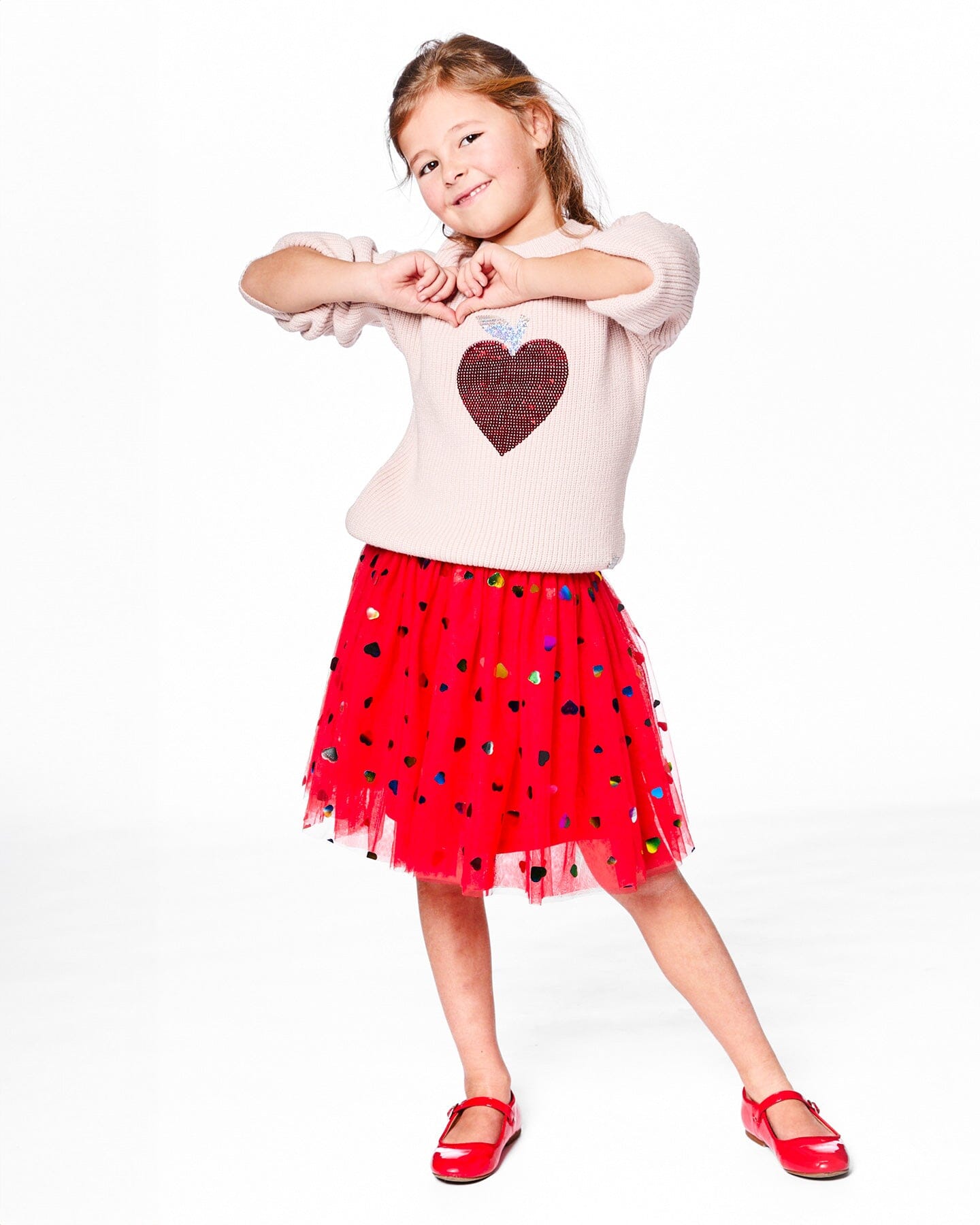Pull en maille blanc rosé avec cœur à paillettes