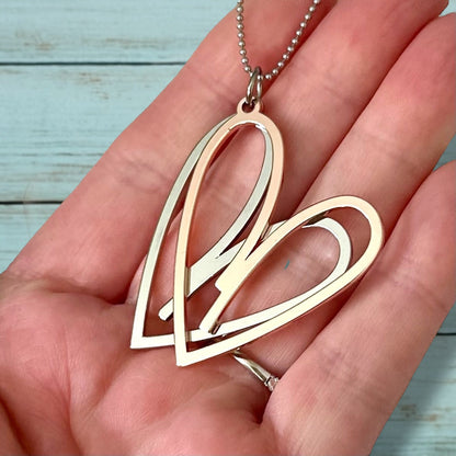 Collier double cœur – Long, métaux mélangés, pendentif or rose et argent