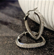 Style MELFI Silver: Abstract Heart Shaped Hoops embedded with Zirconia Gemstones