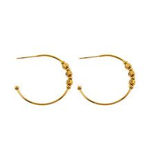 CHARIS: Classic Round Hoop Earrings Anchoring a Bevy of Charm Beads