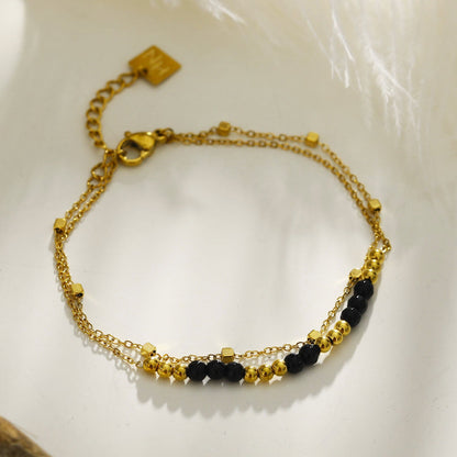HILDA : Bracelet deux-en-un perles carrées et perles rondes en noir et or.