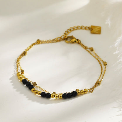 HILDA : Bracelet deux-en-un perles carrées et perles rondes en noir et or.