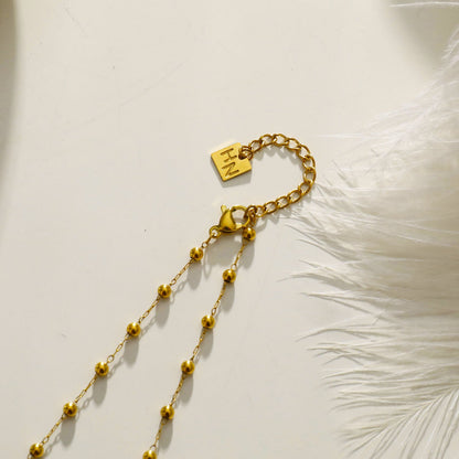 SANTA CRUZ Noir : Collier ras du cou en perles d'onyx noir et or