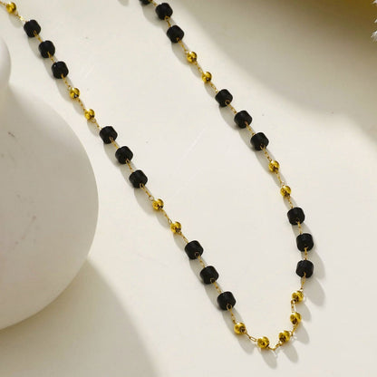 SANTA CRUZ Noir : Collier ras du cou en perles d'onyx noir et or