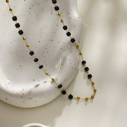 SANTA CRUZ Noir : Collier ras du cou en perles d'onyx noir et or