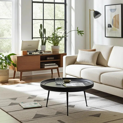 Round coffee table in black-finished mango wood